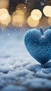 Winter love symbol Blue heart on snow with bokeh background Royalty Free Stock Photo