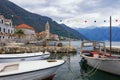 Winter Mediterranean landscape. Seaside village and fishing boats in harbor. Montenegro, view of Kotor Bay and Stoliv village