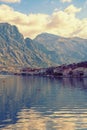 Winter Mediterranean landscape. Small town at foot of mountains. Montenegro, Bay of Kotor. View of Prcanj town