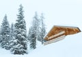 Winter misty mountain and wood house