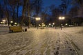 Winter morning in the Mariinsky park. Walking in the winter park along the empty curved alley with benches and lanterns