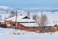 Winter morning view of the village house by Baikal lake.