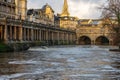 Pulteney Weir in flood, early morning sunlight Royalty Free Stock Photo