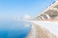 Fog on Songhua River and tall buildings in fog on both sides of the river after snow in Jilin City, Jilin Province