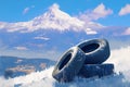 Winter mountain landscape with four black tires in foreground Royalty Free Stock Photo