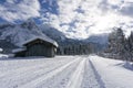 Winter mountain landscape with groomed ski track and snow covered trees along the road Royalty Free Stock Photo