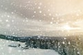 Winter mountain landscape. Old wooden houses on snowy clearing on background of mountain ridge, spruce forest and cloudy sky. Royalty Free Stock Photo