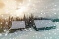 Winter mountain landscape. Old wooden houses on snowy clearing on background of mountain ridge, spruce forest and cloudy sky. Royalty Free Stock Photo