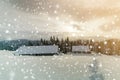 Winter mountain landscape. Old wooden houses on snowy clearing on background of mountain ridge, spruce forest and cloudy sky. Royalty Free Stock Photo