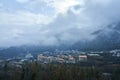 Winter mountain landscape. Small town between mountains. A cloud hangs over the city Royalty Free Stock Photo