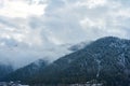 Winter mountain landscape. Small town between mountains. A cloud hangs over the city Royalty Free Stock Photo