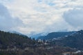 Winter mountain landscape. Small town between mountains. A cloud hangs over the city Royalty Free Stock Photo