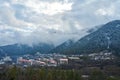 Winter mountain landscape. Small town between mountains. A cloud hangs over the city Royalty Free Stock Photo