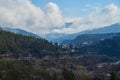 Winter mountain landscape. Small town between mountains. A cloud hangs over the city Royalty Free Stock Photo