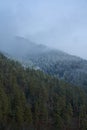 Winter mountain landscape. Small town between mountains. A cloud hangs over the city Royalty Free Stock Photo