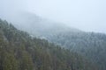 Winter mountain landscape. Small town between mountains. A cloud hangs over the city Royalty Free Stock Photo