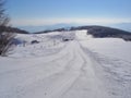 Trail to cross-country skiing.Fresh snow groomer tracks on a ski piste. cable car in the snow