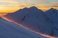 Winter mountain panorama landscape at sunset, West Tatras. View from Volovec to the Rohace. Colorful sky and illuminated by the Royalty Free Stock Photo