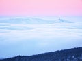 Winter mountain peak with observatory above mist