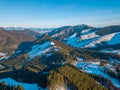 Winter Mountain Peaks and a Valley at a Ski Resort on a Sunny Day. Aerial View Royalty Free Stock Photo