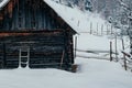 Winter mountain rural landscape with wooden house