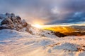 Winter mountain Sunset. Beautiful winter landscape at sunset with clouds and snow over the mountain cliffs