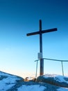 Winter mountain. Wooden cross on rocky mountain summit. Royalty Free Stock Photo