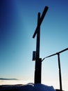 Winter mountain. Wooden cross on rocky mountain summit. Royalty Free Stock Photo