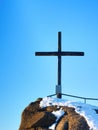 Winter mountain. Wooden cross on rocky mountain summit. Royalty Free Stock Photo