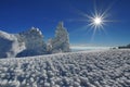 Winter mountain landscape. Sun, snow and ice at high altitude - Ciucas Mountains, landmark attraction in Romania Royalty Free Stock Photo