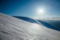 Winter mountains covered with snow. Sun in blue sky Royalty Free Stock Photo