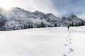 Winter mountains and man walking through snow. Footsteps in snow Royalty Free Stock Photo