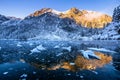 Winter mountains. Winter scene. Snowy mountains with sunshine reflecting in ice. Beautiful landscape with icy blue forground. Wint