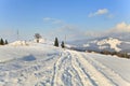 Winter mountains, ski paths across deep snow, blue sky with clouds. Royalty Free Stock Photo
