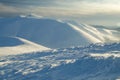 Winter mountains snowy panorama in sunset.