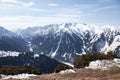 Winter natural landscape, mountain range. Panoramic view from top of slope on snow capped mountains. Karakol ski resort Royalty Free Stock Photo