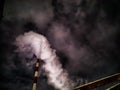 Winter night industrial landscape. Coal-fired power station with smoking chimneys against dramatic dark sky. Air Royalty Free Stock Photo