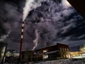 Winter night industrial landscape. Coal-fired power station with smoking chimneys against dramatic dark sky. Air Royalty Free Stock Photo