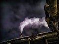 Winter night industrial landscape. Coal-fired power station with smoking chimneys against dramatic dark sky. Air Royalty Free Stock Photo