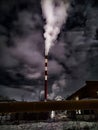 Winter night industrial landscape. Coal-fired power station with smoking chimneys against dramatic dark sky. Air Royalty Free Stock Photo