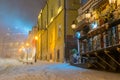 Winter night landscape, evening in the night snowy street under snowfall