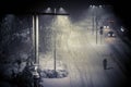 Winter night landscape, street with lanterns, a man walking along the road Royalty Free Stock Photo