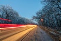 Winter night road driving in dark forest Royalty Free Stock Photo