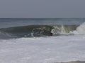 Bodyboarder on a Winter noreaster waves at indian river inlet