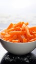 Winter nourishment Frozen cut carrot in white bowl, healthy food