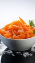 Winter nourishment Frozen cut carrot in white bowl, healthy food