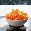 Winter nourishment Frozen cut carrot in white bowl, healthy food