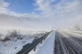 Winter old American Country landscape with rustic houses, cars and fences covered in snow Royalty Free Stock Photo