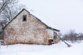 Winter, old dilapidated barn. A lot of snow around