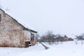 Winter, old dilapidated barn. A lot of snow around